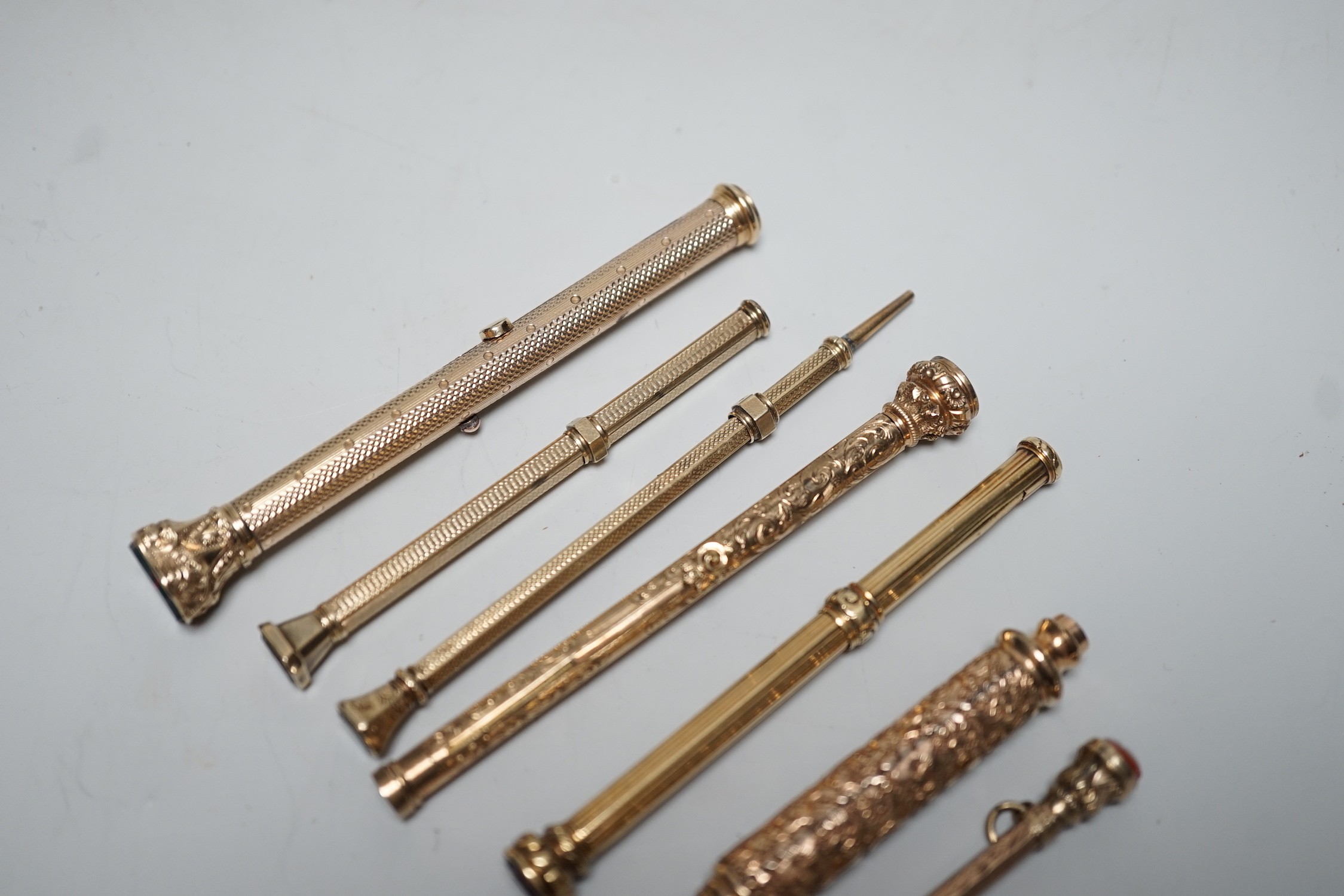 Seven assorted yellow metal overlaid and gem set propelling pencils